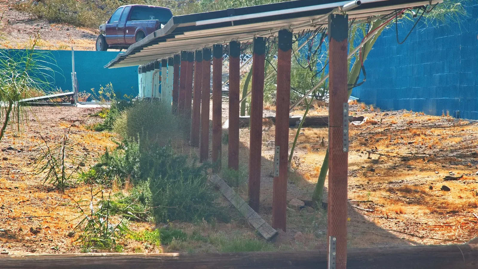 May 2026 The wash beneath the panels is turning green with rosemary and succulents.